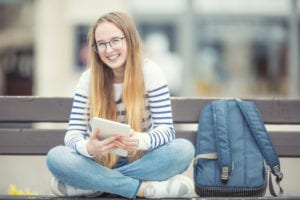 girl sitting on a bench and smiling
