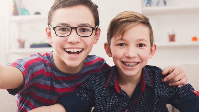 happy-boys-smiling-with-braces-and-corrected-teeth